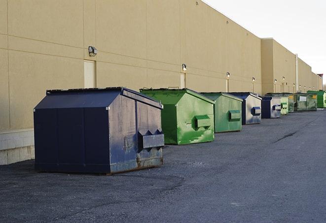 a series of colorful, utilitarian dumpsters deployed in a construction site in Brigantine